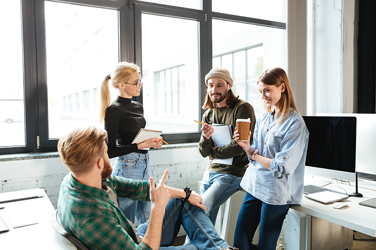 Friendly communication of colleagues in the office during a joint discussion — a typical psychological portrait of people with the Bear chronotype