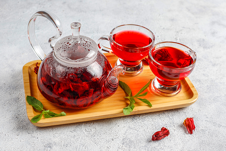 Hot Hibiscus Tea in a Glass Mug and Glass Teapot