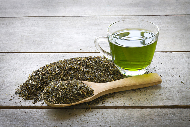 Glass cup with green tea