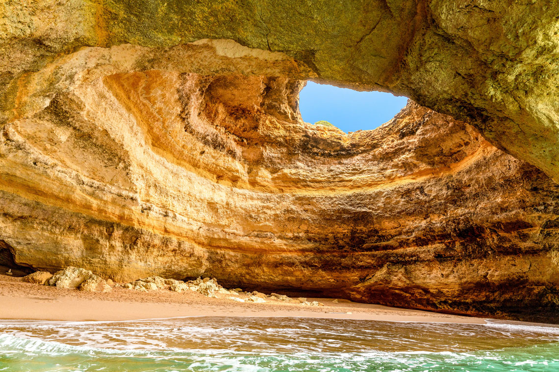 An extraordinary sea cave is located on the beach of the small village of Benagil in the Portuguese Algarve region, in the southern part of the country. This unique cave is in close proximity to the world famous Praia da Marinha beach and is the most popular of all the sea caves in Portugal.