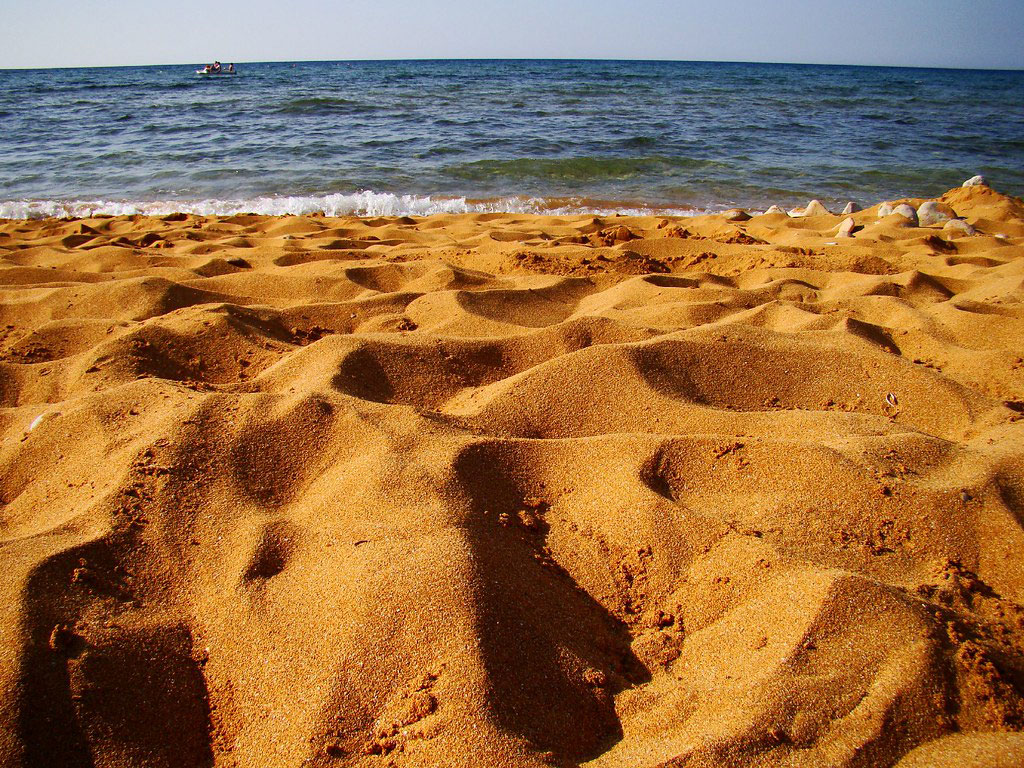 La arena de esta playa tiene un color increíble que cambia a lo largo del día. Por la mañana es de color amarillo dorado, dorado brillante en los rayos del sol naciente, por la tarde tiene un tono rosa-naranja, tan similar al color de un durazno maduro. Y por la noche, la playa se convierte en un tumulto de arena naranja increíblemente saturada.