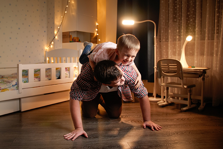 Happy Laughing Little Boy Jumping on Father’s Back and Riding on Him