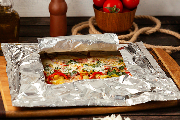 Vegetable pizza in aluminum foil