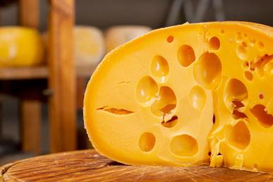 Where do holes in cheese come from?